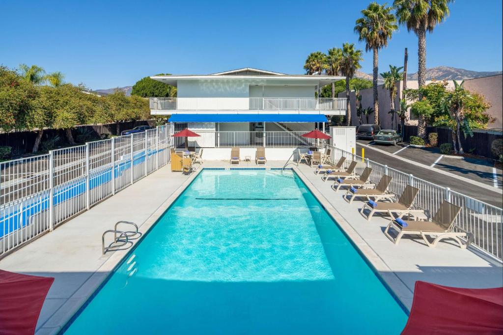 a swimming pool with a pool table and chairs at Motel 6-Santa Barbara, CA - State Street in Santa Barbara