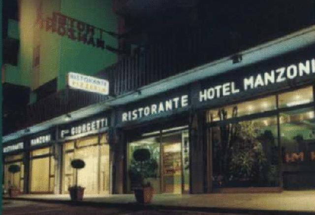 a store front of a hotel with signs on it at Hotel Manzoni in Ponte San Giovanni