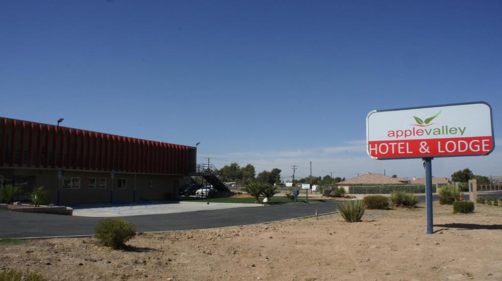 a sign for a motel and lodge in the desert at Apple Valley Hotel & Lodge in Apple Valley