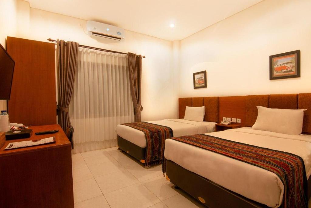 Een bed of bedden in een kamer bij Diva Lombok Resort