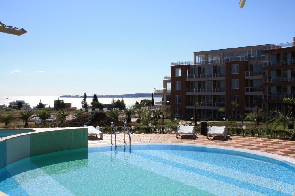 a large swimming pool next to a building at Great Choice Apartment in Chernomorets