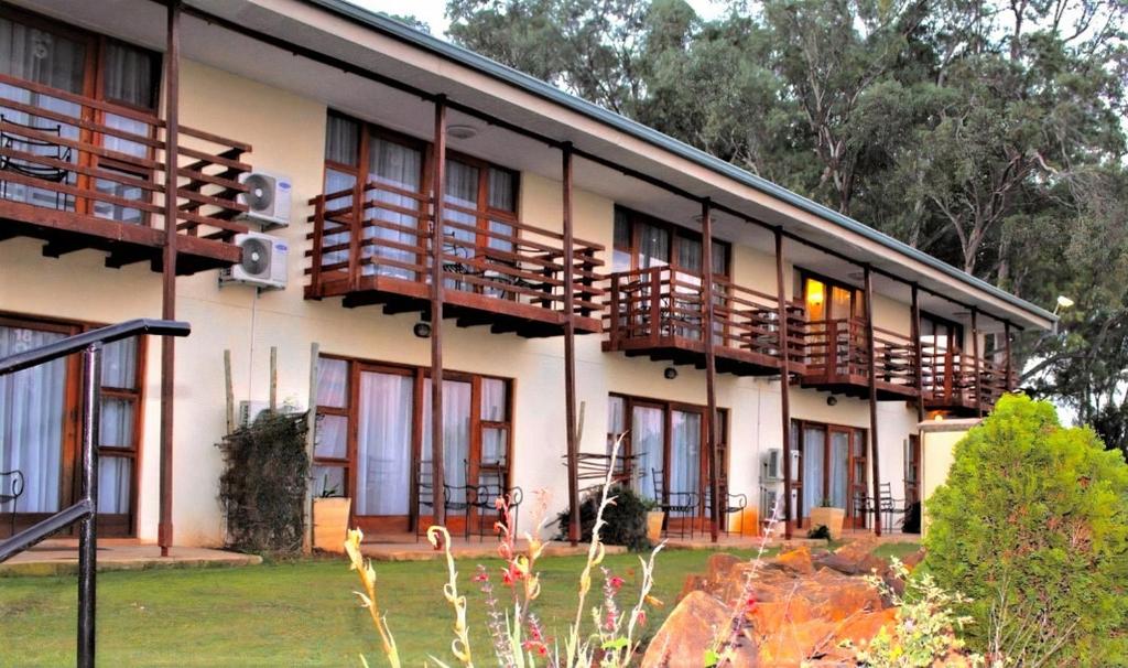 a building with balconies on the side of it at Sandford Park Country Hotel in Bergville