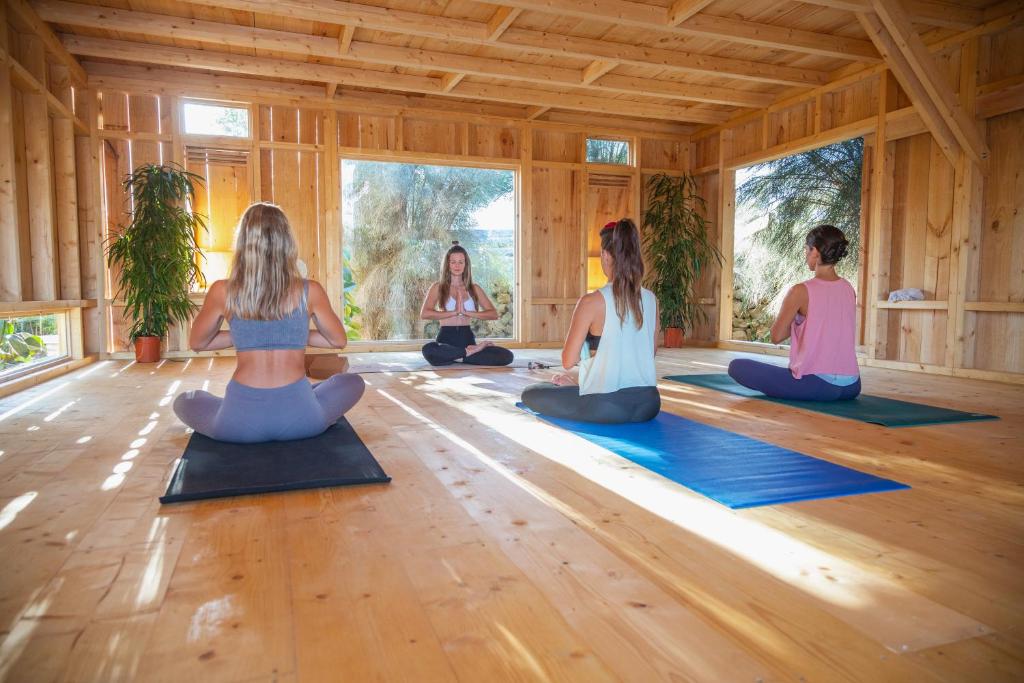 a group of women sitting in a yoga class at Surfescape Fuerteventura in Lajares