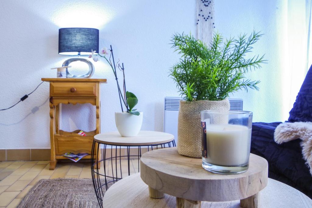 a living room with a table with a glass of milk at Studio à 100m de la plage avec balcon - 66 in Canet-en-Roussillon