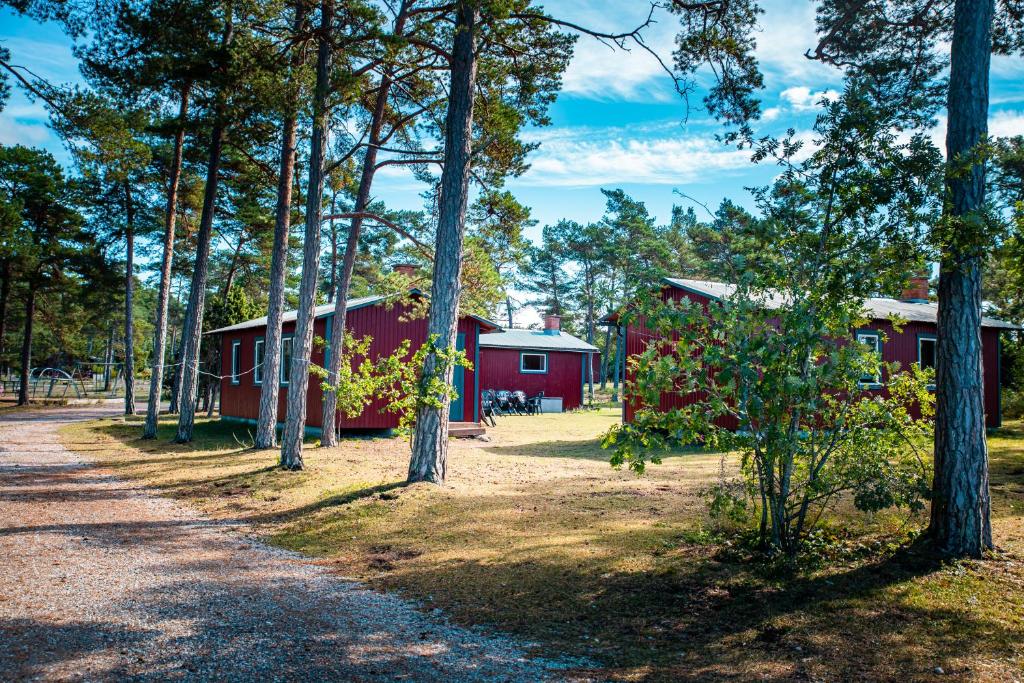 a couple of red buildings in the woods at Lickershamns Semesterby in Lickershamn