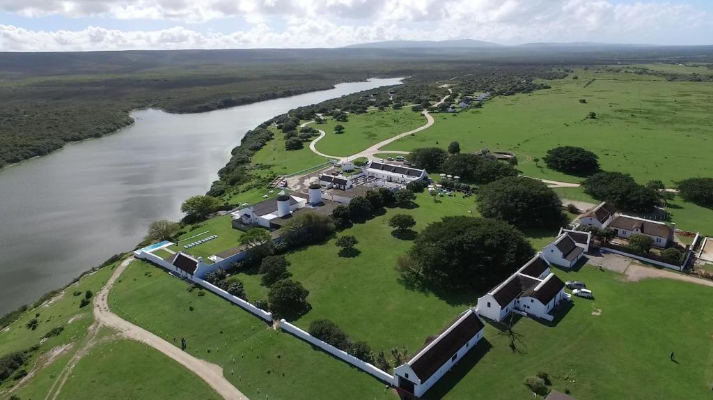 an aerial view of a house next to a river at De Hoop Collection - Vlei Cottages in De Hoop Nature Reserve