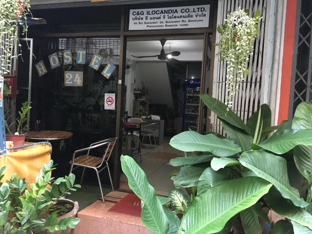 a store entrance with plants in front of it at Hostel 24 in Bangkok