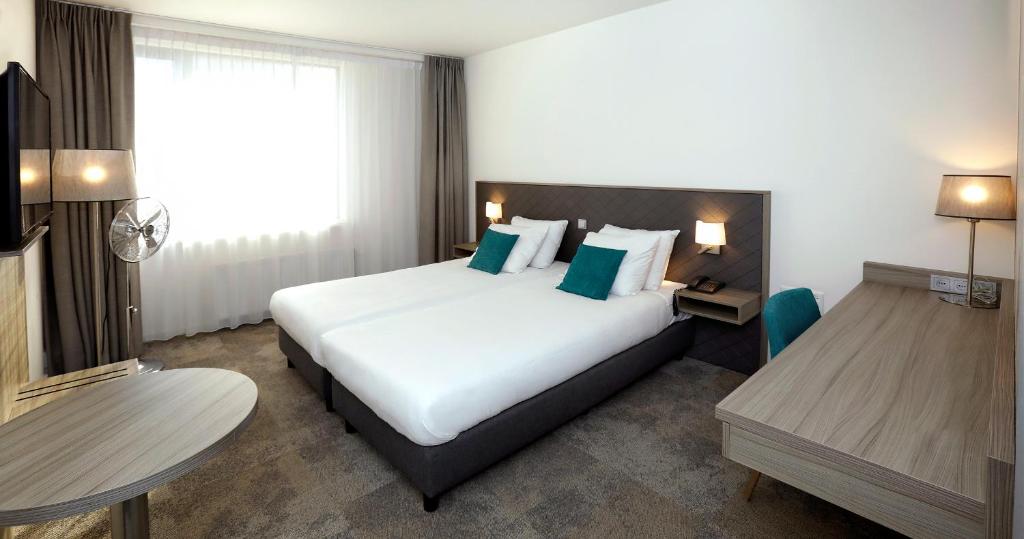 Ένα ή περισσότερα κρεβάτια σε δωμάτιο στο Churchill hotel Terneuzen