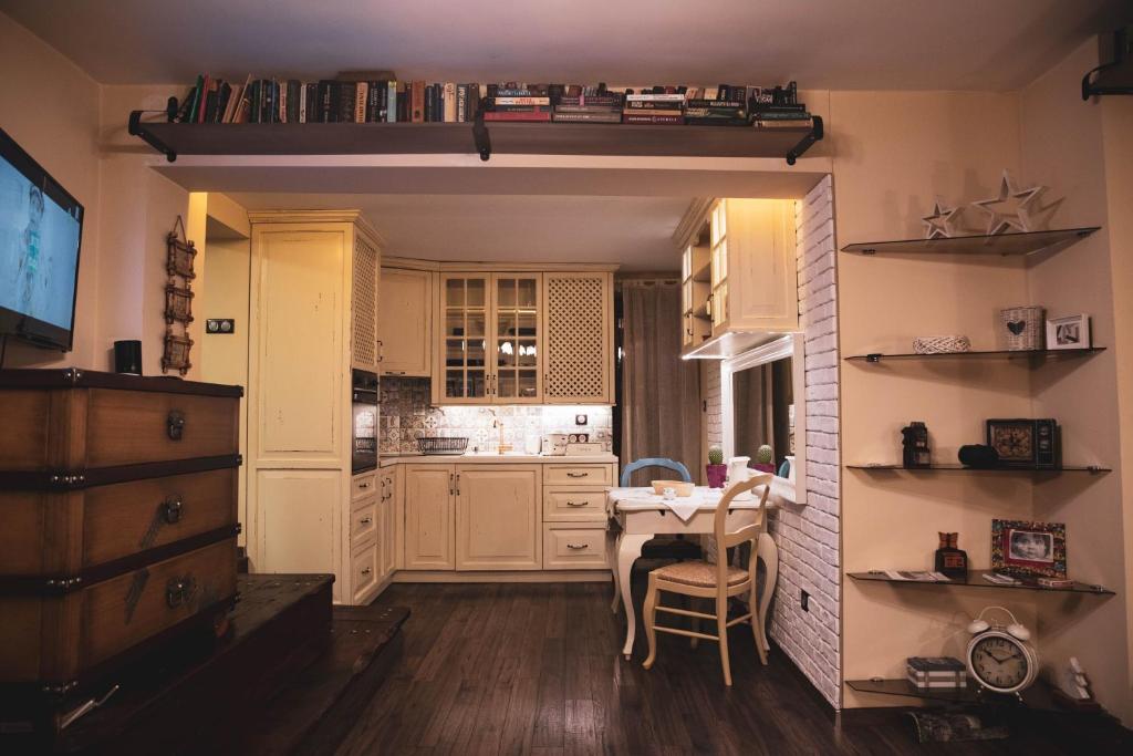 a kitchen with a table and a dining room at Vintage Lozenets Apartment in Sofia