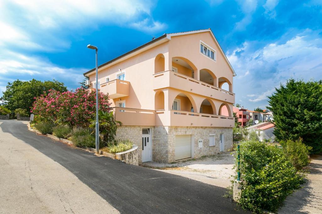a large house with a road in front of it at Apartmani Luka in Kornić