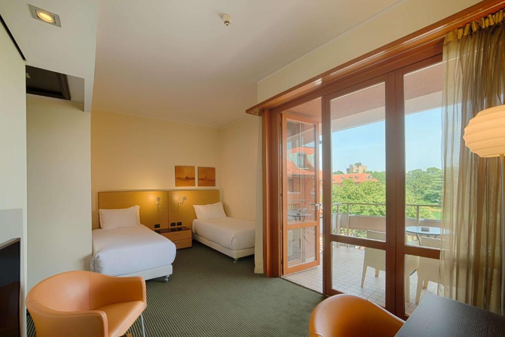 Postel nebo postele na pokoji v ubytování NH Milano 2 Residence