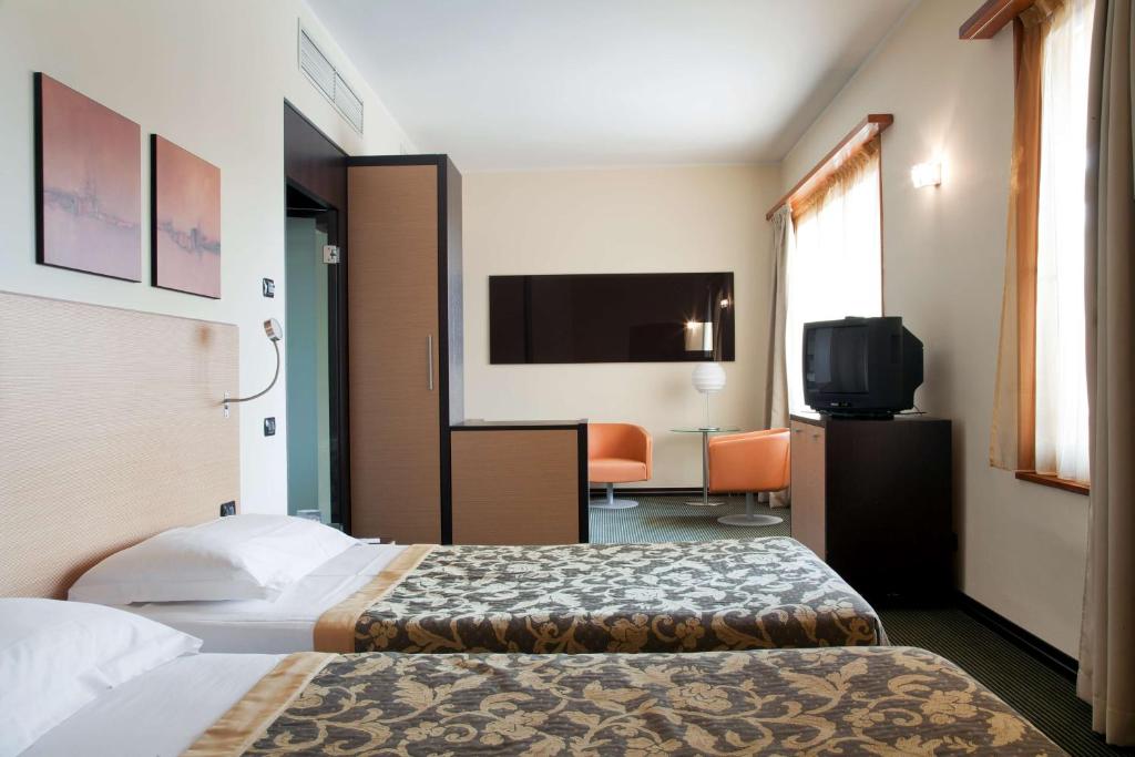 Postel nebo postele na pokoji v ubytování NH Milano 2 Residence