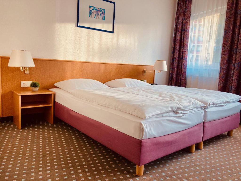 Postel nebo postele na pokoji v ubytování Akzent Congresshotel Hoyerswerda