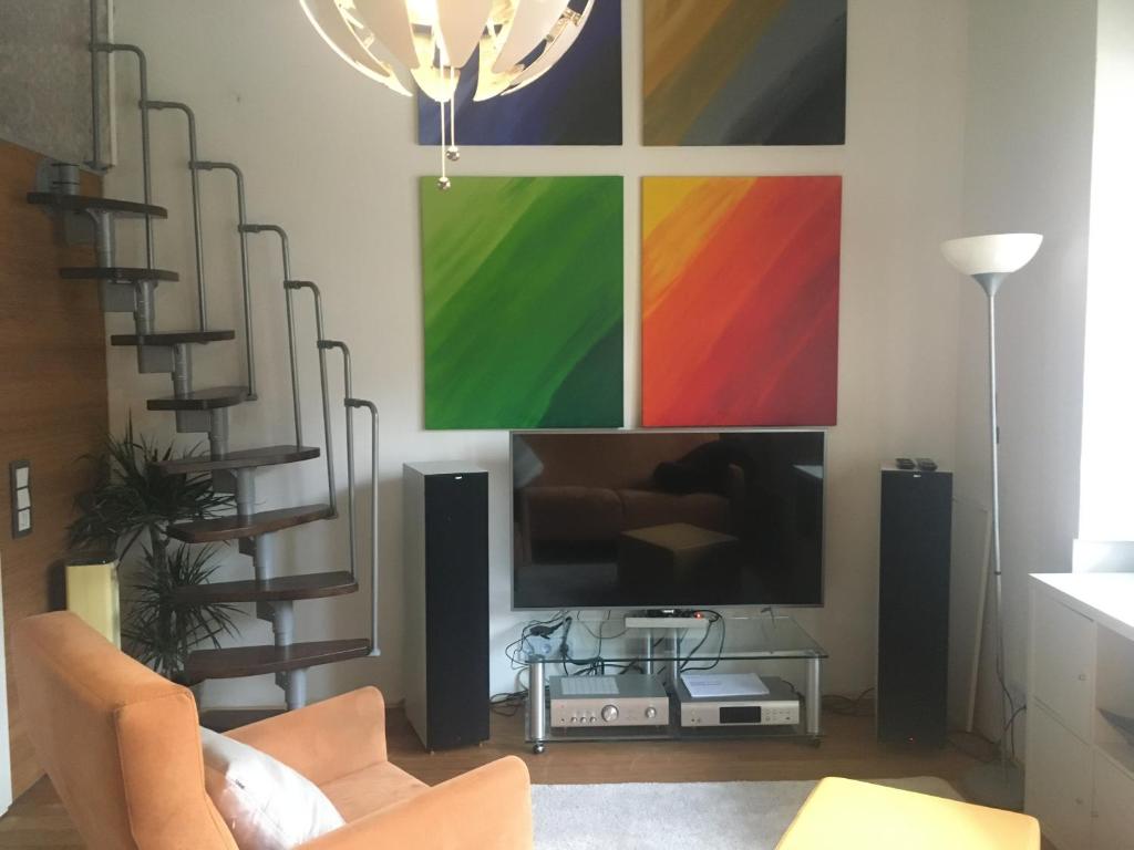 a living room with a large screen tv on a wall at Wiesbaden Mitte, Apartment mit Galerie in Wiesbaden
