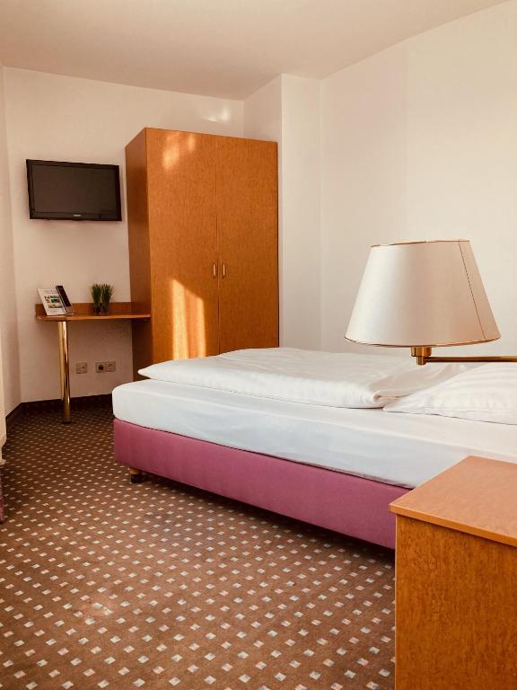Postel nebo postele na pokoji v ubytování Akzent Congresshotel Hoyerswerda