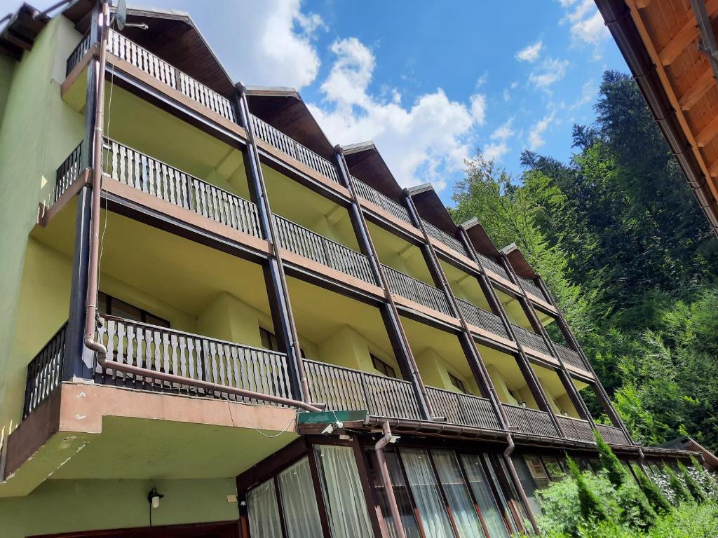 a building with a balcony on the side of it at Ezio House in Braşov