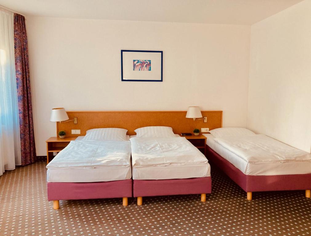 Postel nebo postele na pokoji v ubytování Akzent Congresshotel Hoyerswerda