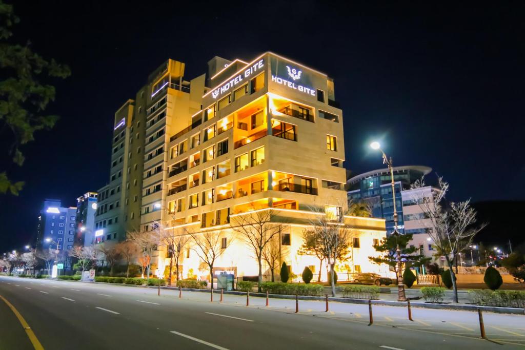 a building on the side of a street at night at Suncheon Hotel Gite in Suncheon