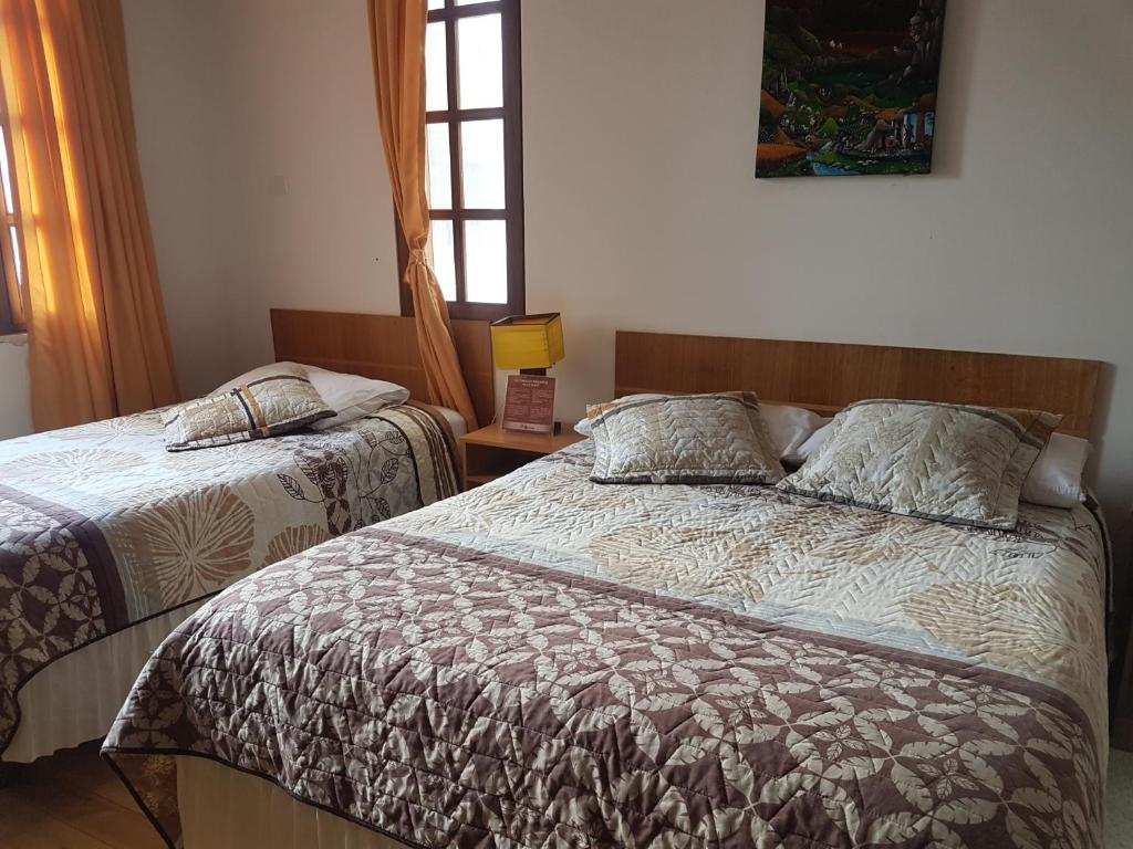 Postel nebo postele na pokoji v ubytování Hotel PrincesaToa