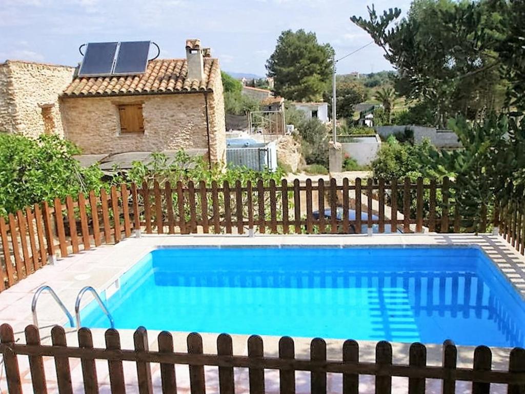 a swimming pool in front of a house at Comfortable Chalet in Masdenverge with Private Pool in Masdenverge