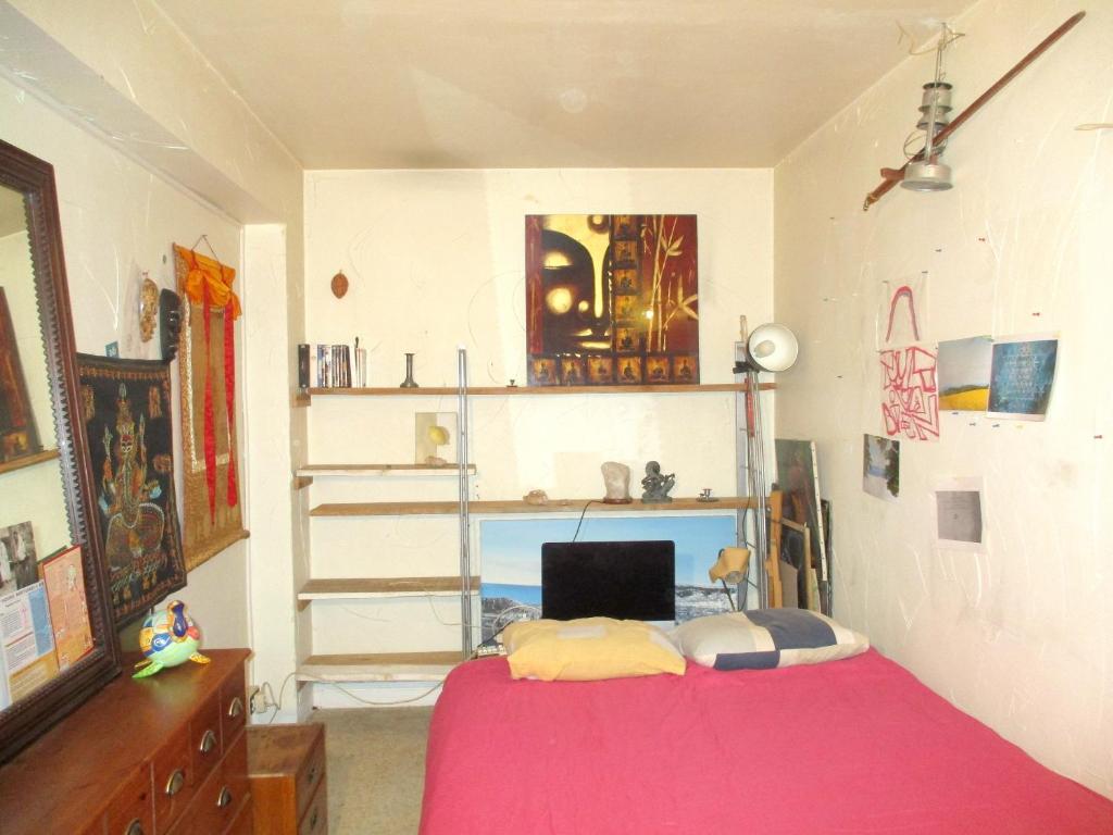 a bedroom with a bed and a desk and shelves at Appartement de 2 chambres avec vue sur la ville a Nice a 3 km de la plage in Nice
