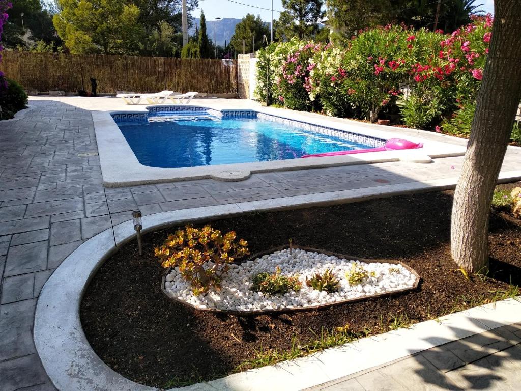a swimming pool in a yard next to a tree at Seaside Villa in Calafat with Private Pool. in Calafat