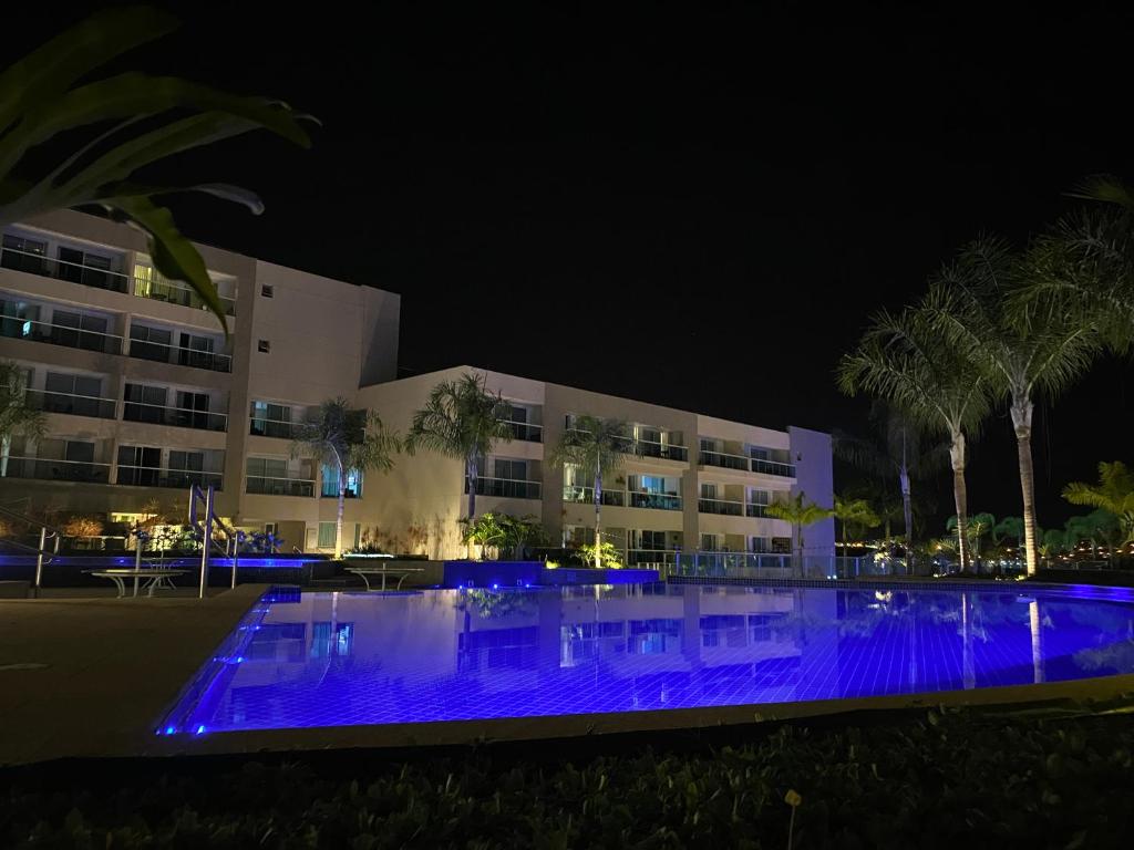 a building with blue lights in front of it at night at Brisas do Lago - Apartamento 8 in Brasilia