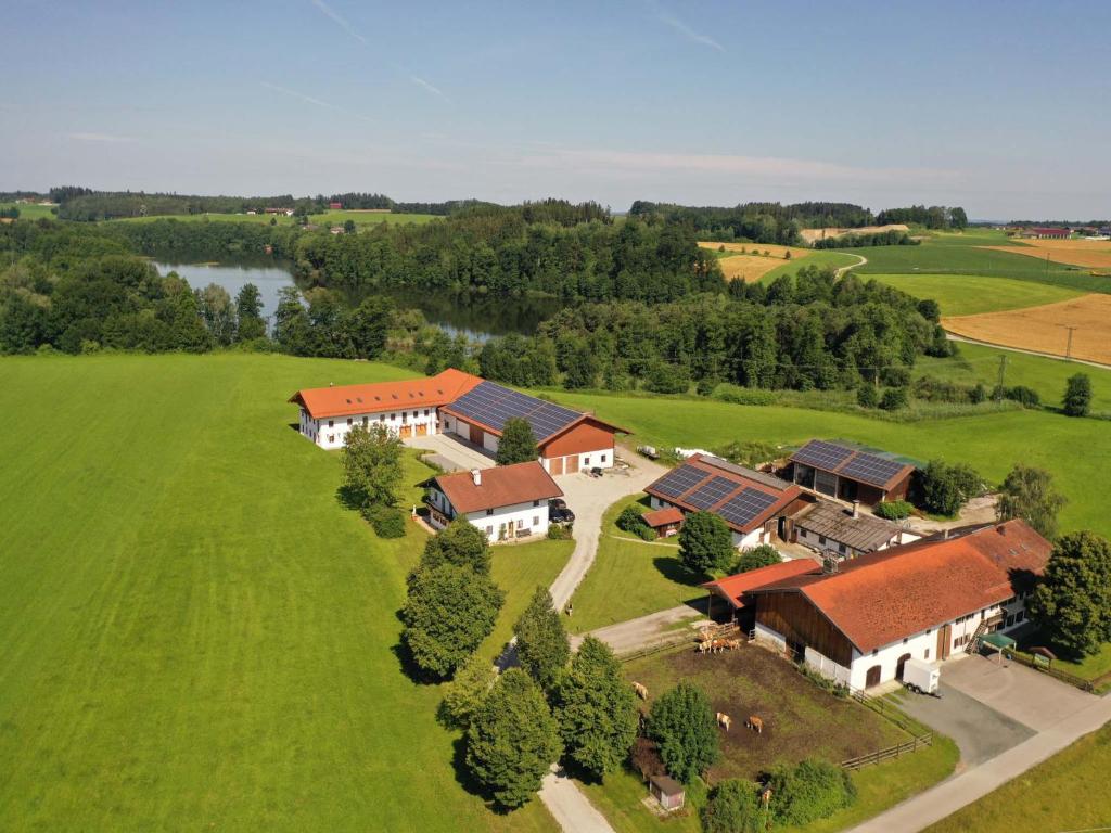 an aerial view of a house in a green field at Rinser See-Hof in Söchtenau
