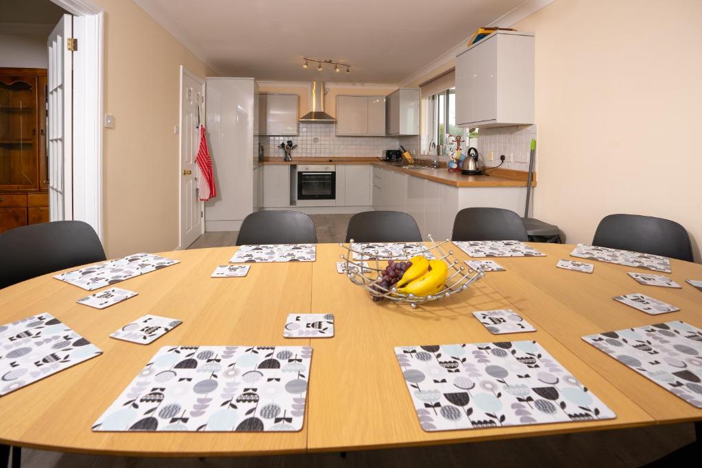 a dining room table with a bowl of bananas on it at Captivating 8-Bed House in Porthleven in Porthleven