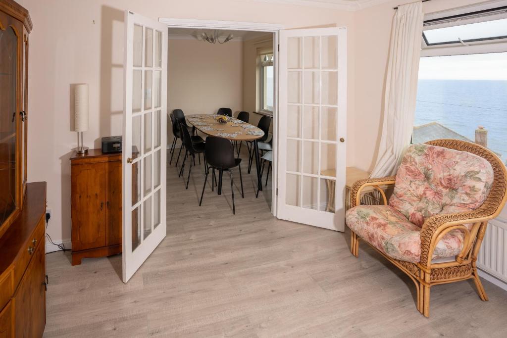 a living room with a chair and a table at Captivating 8-Bed House in Porthleven in Porthleven