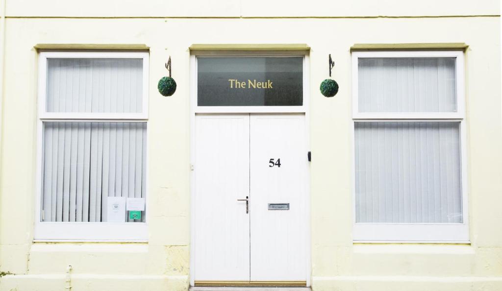 a white building with white doors and windows at The Neuk Anstruther - Sleeps 6 - Dogs Welcome in Anstruther