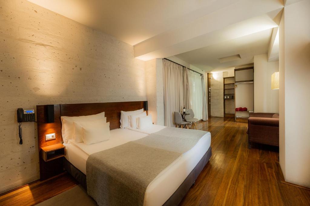 a hotel room with a large bed and a couch at Palla Boutique Hotel in Arequipa