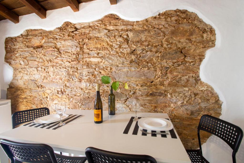 a table in front of a stone wall at Recanto do Sossego in Monsaraz