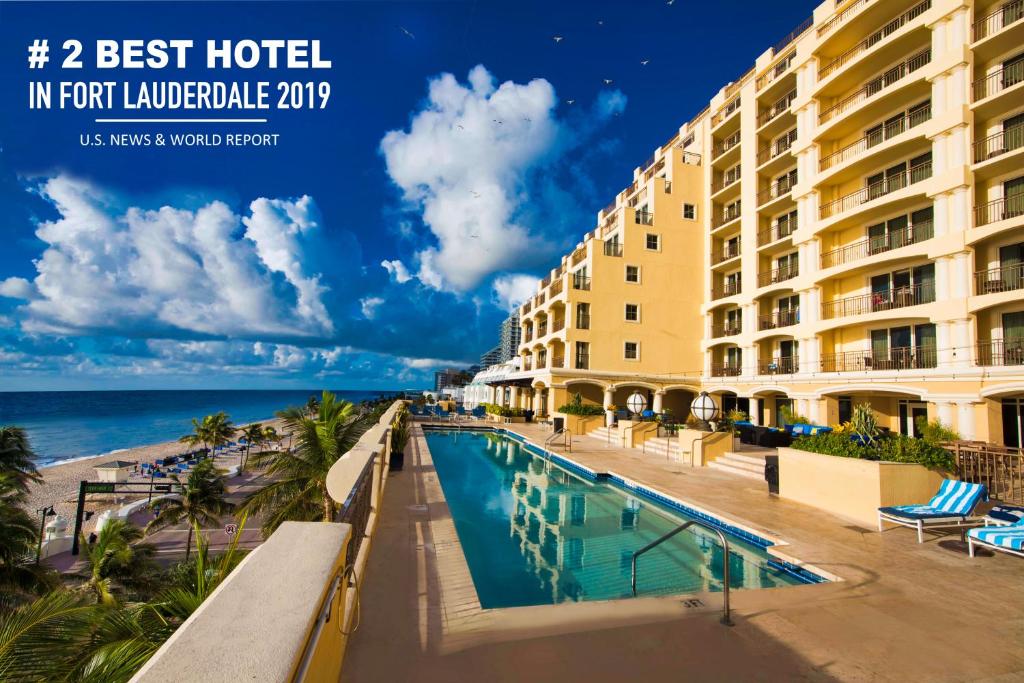 a hotel with a swimming pool next to a beach at Atlantic Luxury Boutique Hotel & Spa in Fort Lauderdale