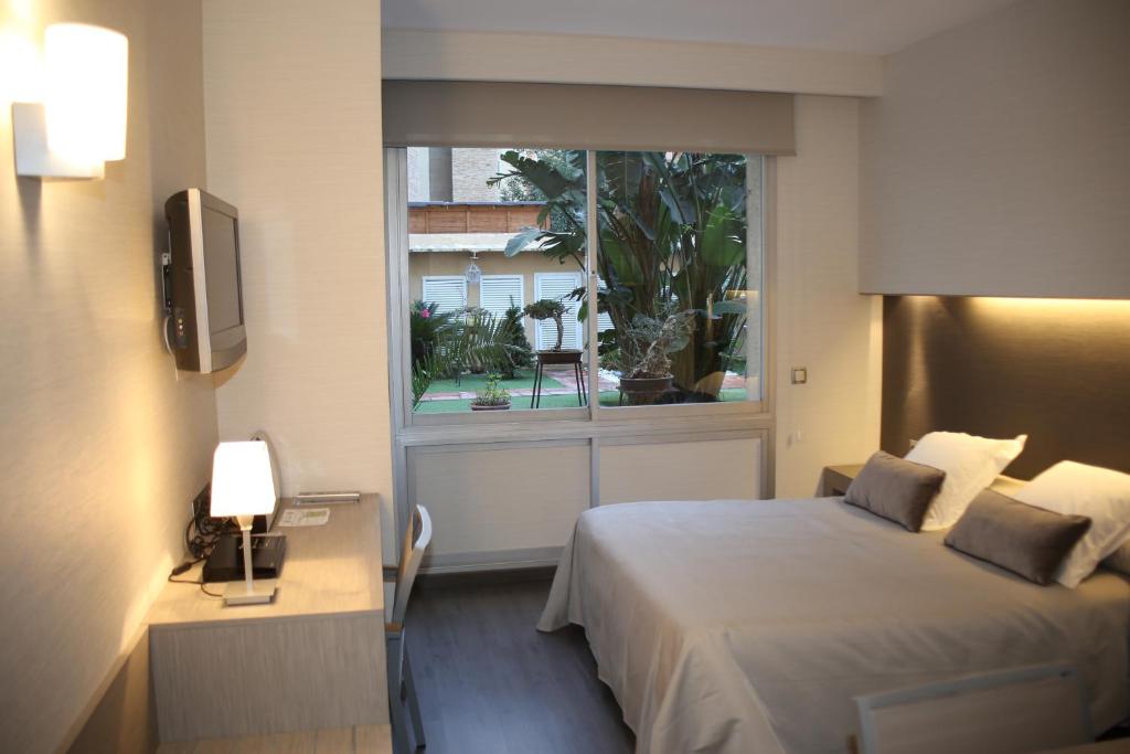 Postel nebo postele na pokoji v ubytování Aparthotel Silver
