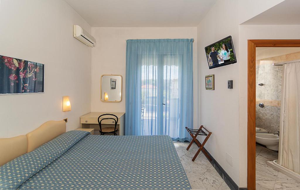 Postel nebo postele na pokoji v ubytování Hotel Mariotti