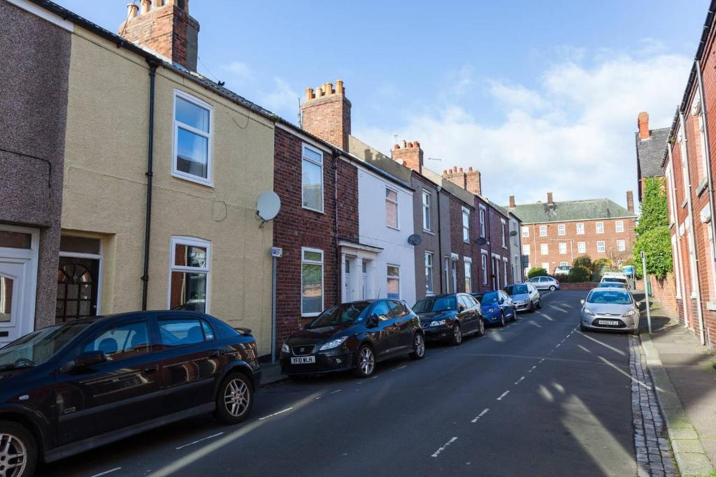 a row of cars parked on the side of a street at Relaxing 2-Bed House Guisborough - Sofabed Option in Guisborough