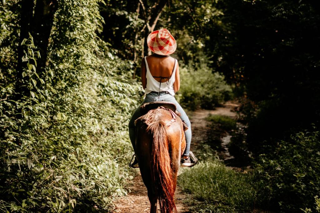 a young girl riding on the back of a horse at Casa Chapolin Boutique Guesthouse in Palomino