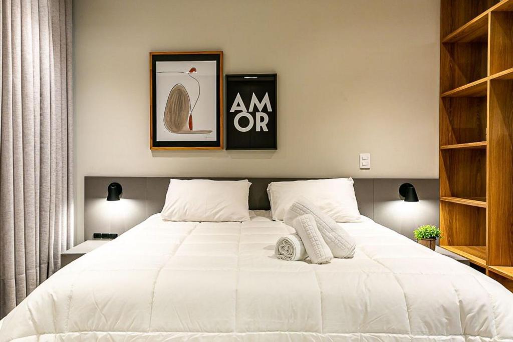 a bedroom with a large white bed in a room at WIFI 350mb | Foodhall | 450m do Shopping #CA14 in Florianópolis