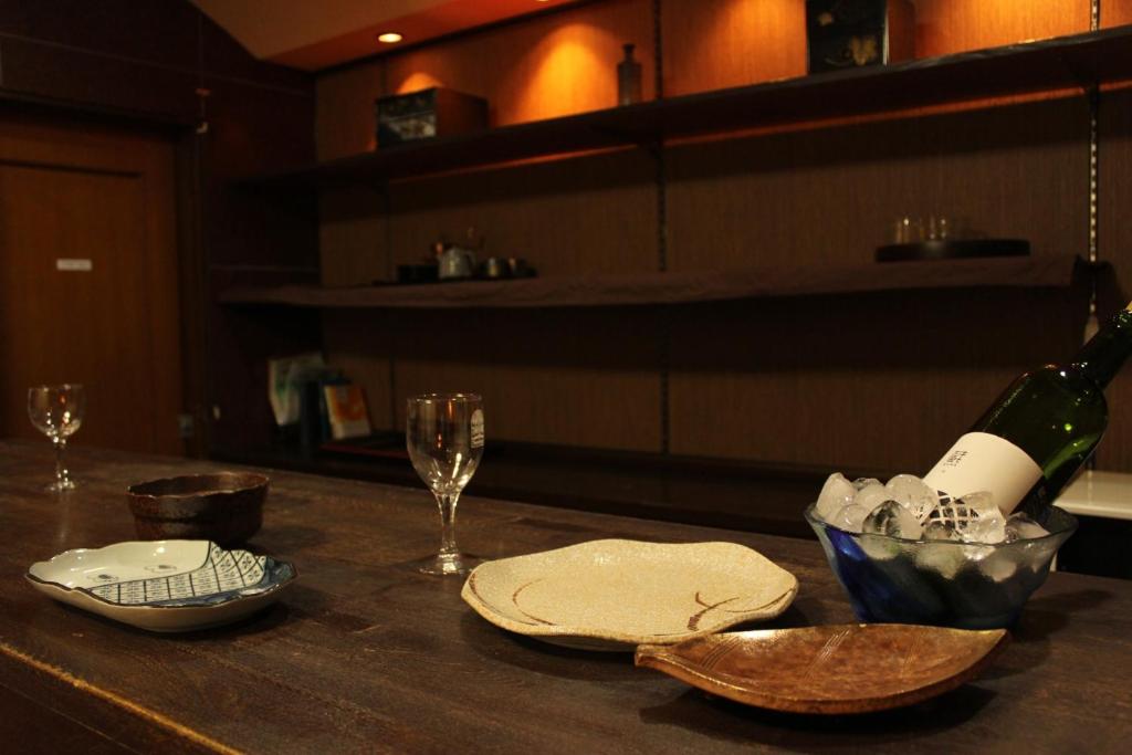 a table with a bottle of wine and a glass at Fuefuki - House - Vacation STAY 10281 in Fuefuki