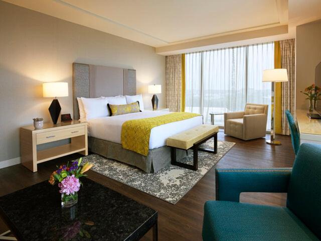 a hotel room with a bed and a living room at Live! Casino & Hotel - Baltimore Washington Airport – BWI in Hanover