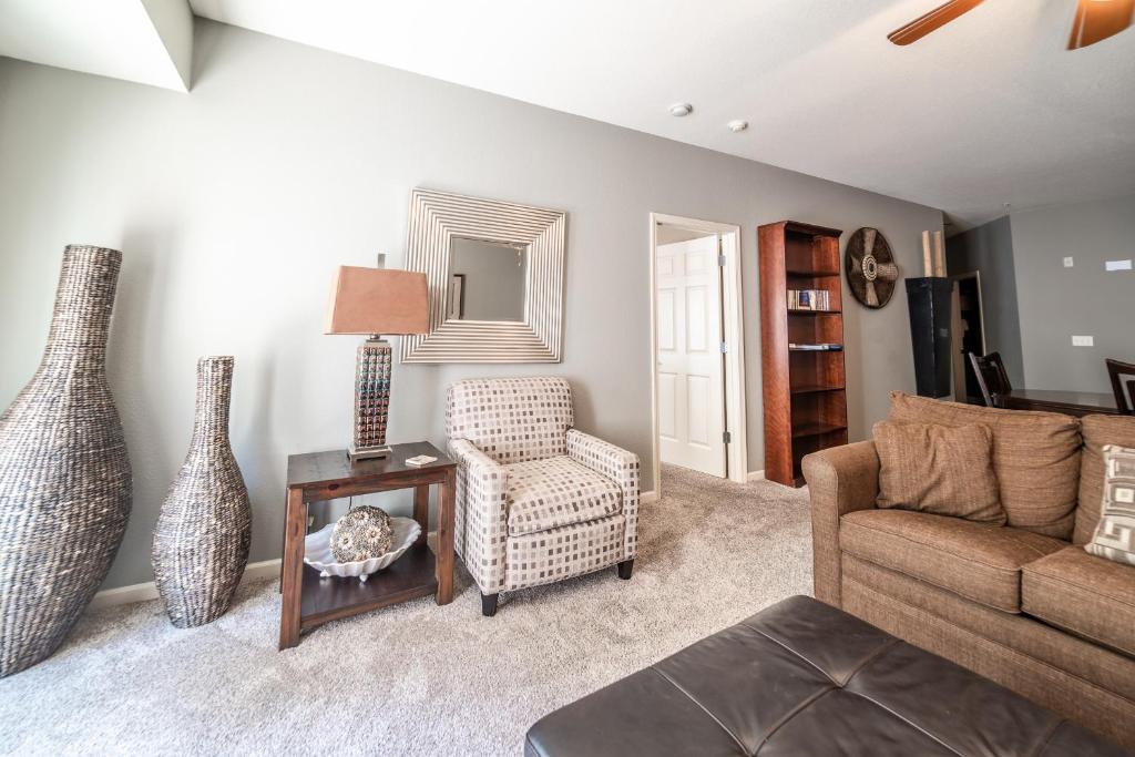 a living room with a couch and a chair and a table at Thousand Hills Golf Resort in Branson