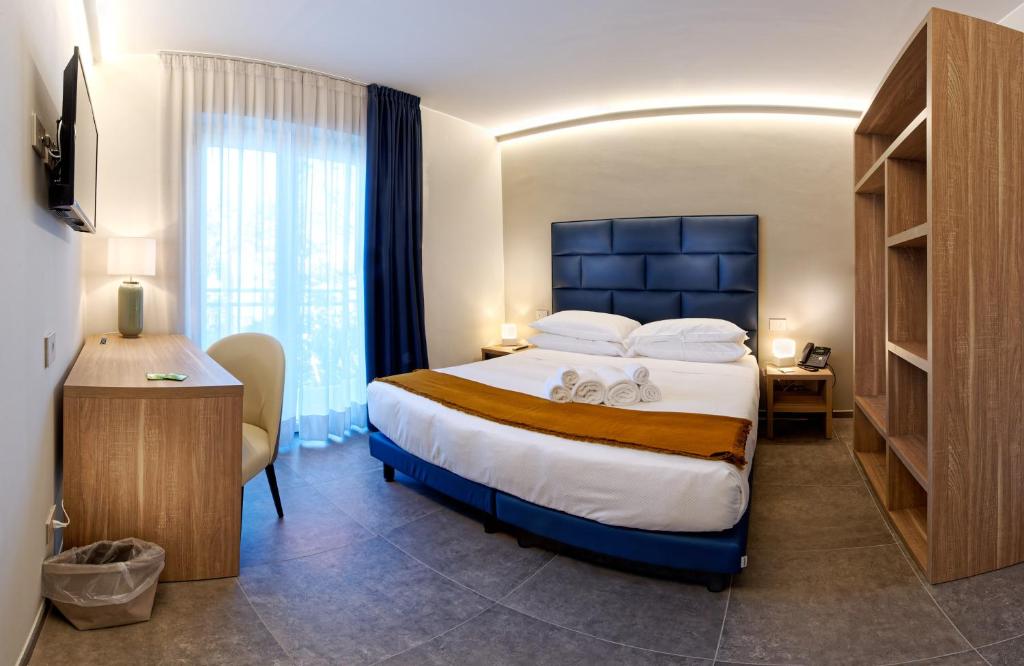 A bed or beds in a room at Albergo Giuan Arma di Taggia