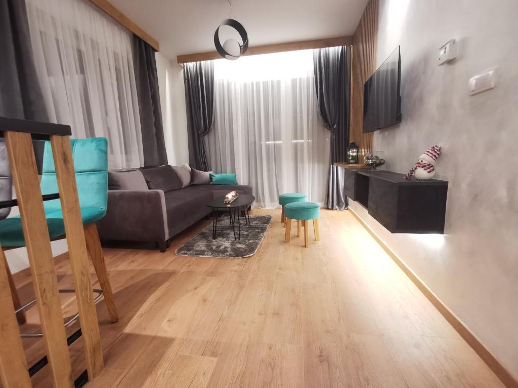 a living room with a couch and a table at Apartmani Zimski Ples Jahorina in Jahorina