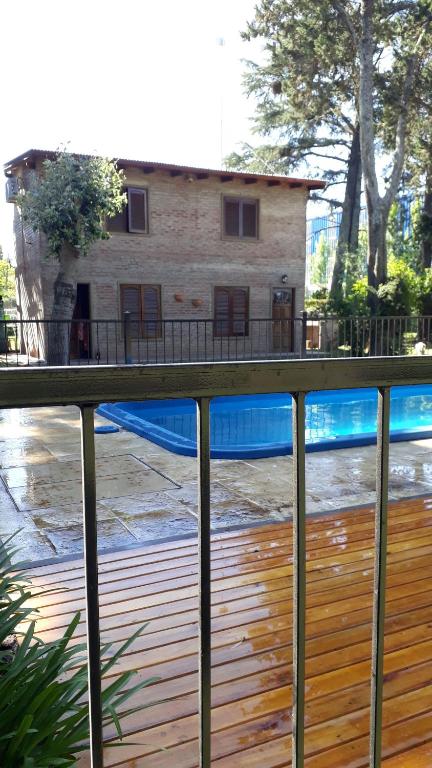 a fence with a pool in front of a house at Los Cabre in San Pedro