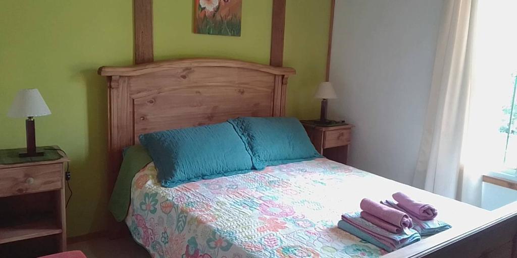 1 dormitorio con 1 cama con toallas en Cabañas los Plátanos en La Granja
