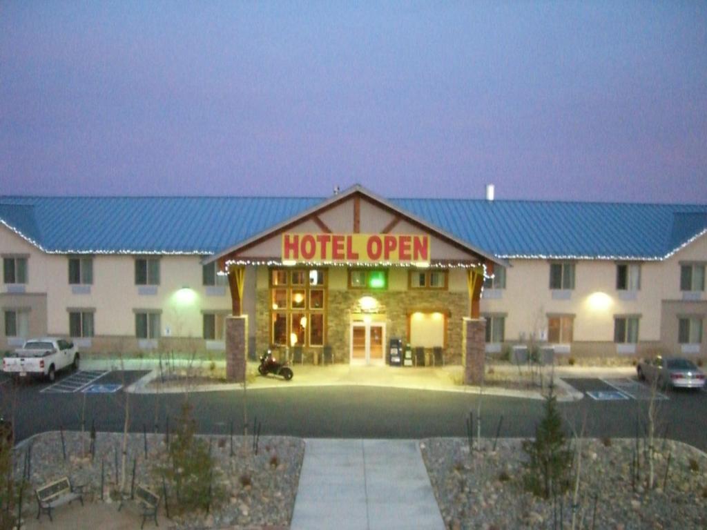 a hotel with a sign that reads hotel open at A Riverside Inn Travelodge by Wyndham in Fairplay