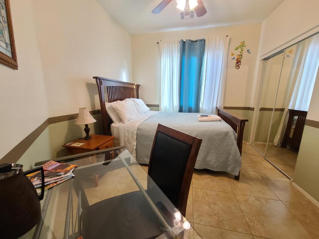 a bedroom with a bed and a desk with a tv at Phoenix home near freeways and airport in Phoenix