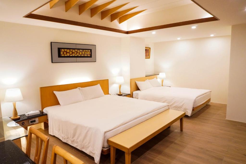 Postel nebo postele na pokoji v ubytování Kao Yuan Hotel - Zhong Zheng