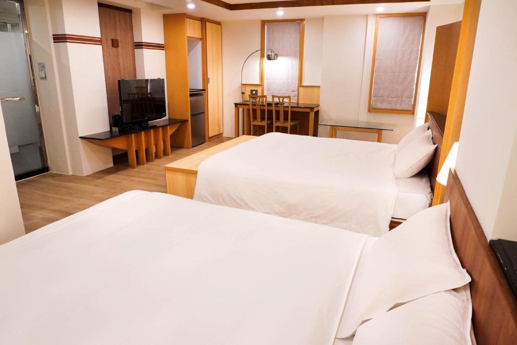 Postel nebo postele na pokoji v ubytování Kao Yuan Hotel - Zhong Zheng